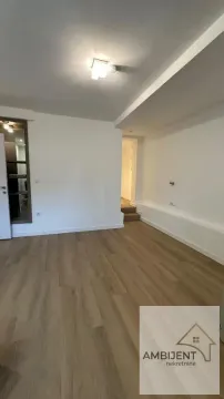 Empty living room with wood flooring and white walls. - image 7