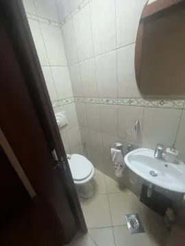A small bathroom with a sink and a toilet. - image 9