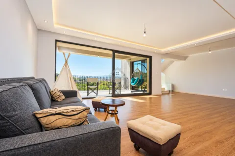 Spacious living room with a sofa set, wooden flooring, and large glass doors leading to the terrace. - image 10