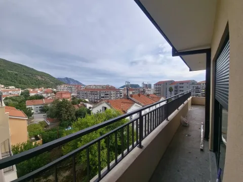 Covered balcony with a view of the city, hills, and the sea. - image 5
