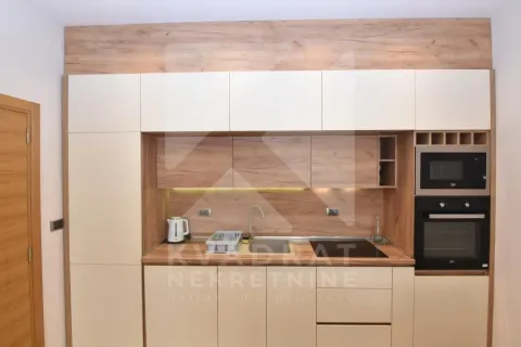 Modern kitchen with wooden elements and built-in appliances. - image 4
