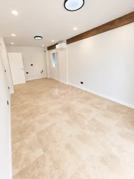 Empty room with ceramic floor tiles and recessed lighting. - image 3