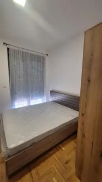Bedroom with a double bed and a wooden wardrobe. - image 8
