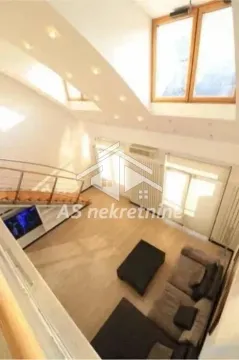 High-angle view of the living room with a high ceiling and skylights. - image 8