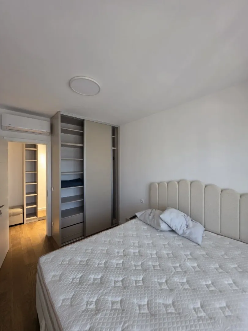 Bedroom with a double bed, fitted wardrobe and a view of the hallway.