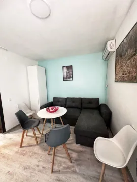 Living room with sofa, dining table, and chairs. - image 7
