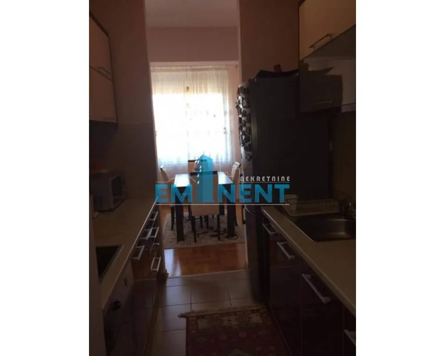 View of the kitchen with a passageway to the dining area with a window.