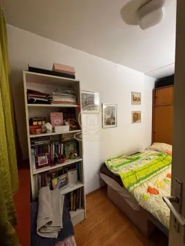 Smaller bedroom with a bed, wardrobe, and a bookshelf. - image 2