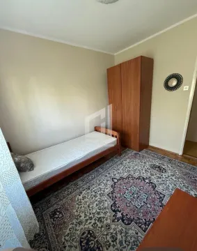 Small bedroom with a single bed, wooden wardrobe and a rug. - image 5
