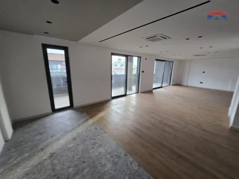 Empty living room with wooden flooring and large glass surfaces. - image 2