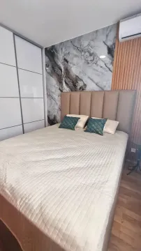 Modern bedroom with a double bed, wardrobe, and a decorative wall. - image 5