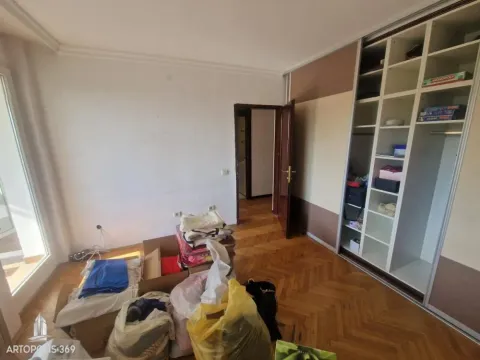 Bedroom with a large built-in wardrobe and parquet flooring. - image 6