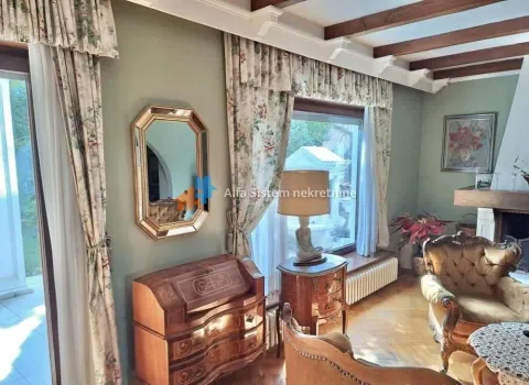 Living room with classic furniture, wooden ceiling beams and a fireplace. - image 15