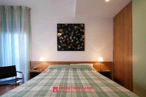 Furnished bedroom with a double bed, bedside lamps, and a fitted wardrobe. - image 16