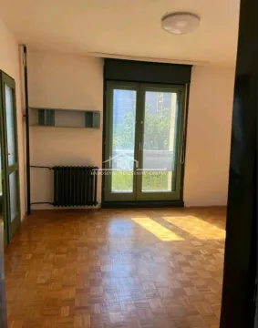 Empty room with parquet flooring and balcony doors. - image 4