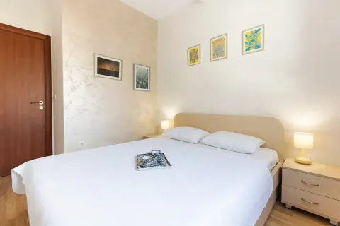 Bedroom with a double bed, nightstands, and pictures on the wall. - image 11