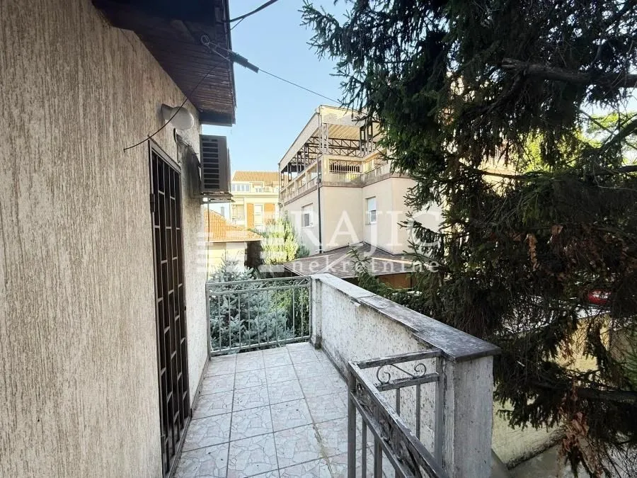Exterior view of the building terrace with a metal railing.