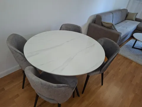 Living room with a dining table and sofa set. - image 6