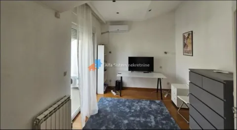 Living room with a desk, TV, and access to the terrace. - image 11