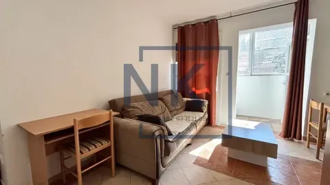 Living room with a sofa set, a desk, and access to the terrace. - image 2
