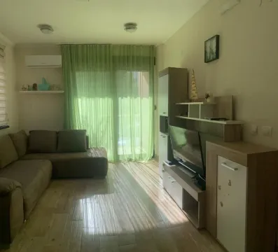 Living room with a sofa set, TV unit, and access to the terrace. - image 3