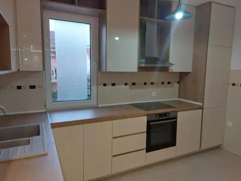 Modern kitchen with built-in appliances and cabinetry. - image 12