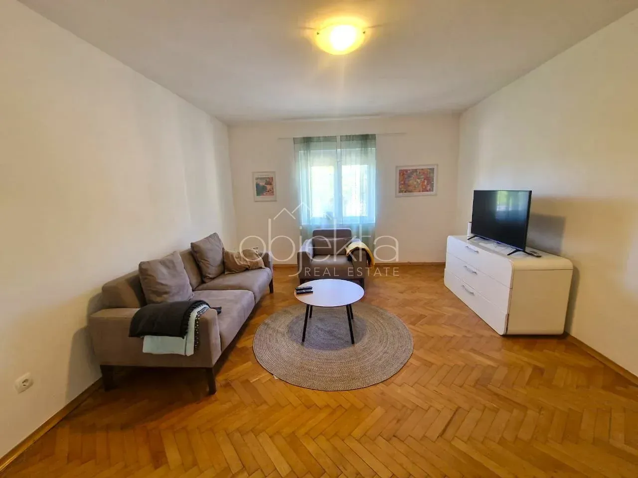 Living room with sofa, coffee table and television.