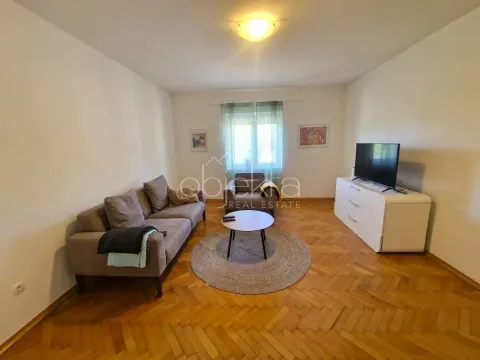 Living room with sofa, coffee table and television. - image 8
