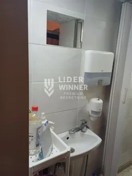 View of the washbasin with a mirror in the bathroom. - image 12