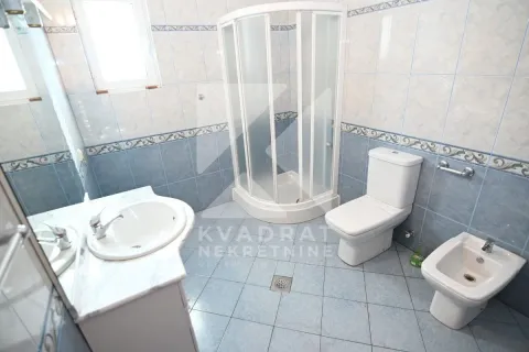 Bathroom with a shower cabin, washbasin, toilet, and bidet. - image 26
