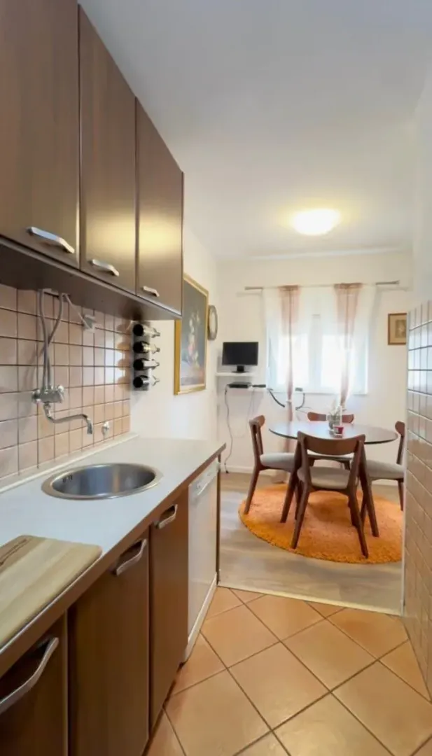 Kitchen with wooden cabinetry and an adjoining dining area.