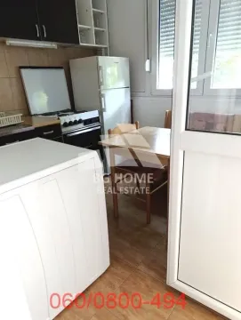 Small kitchen with a dining table and basic kitchen units. - image 6