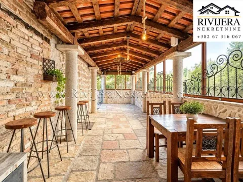 Covered terrace with wooden beam structure, stone pillars, and a dining table. - image 5