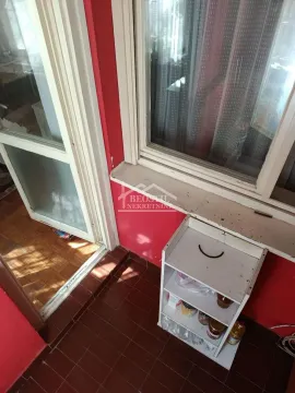 Small enclosed balcony with a shelf and a window view. - image 13