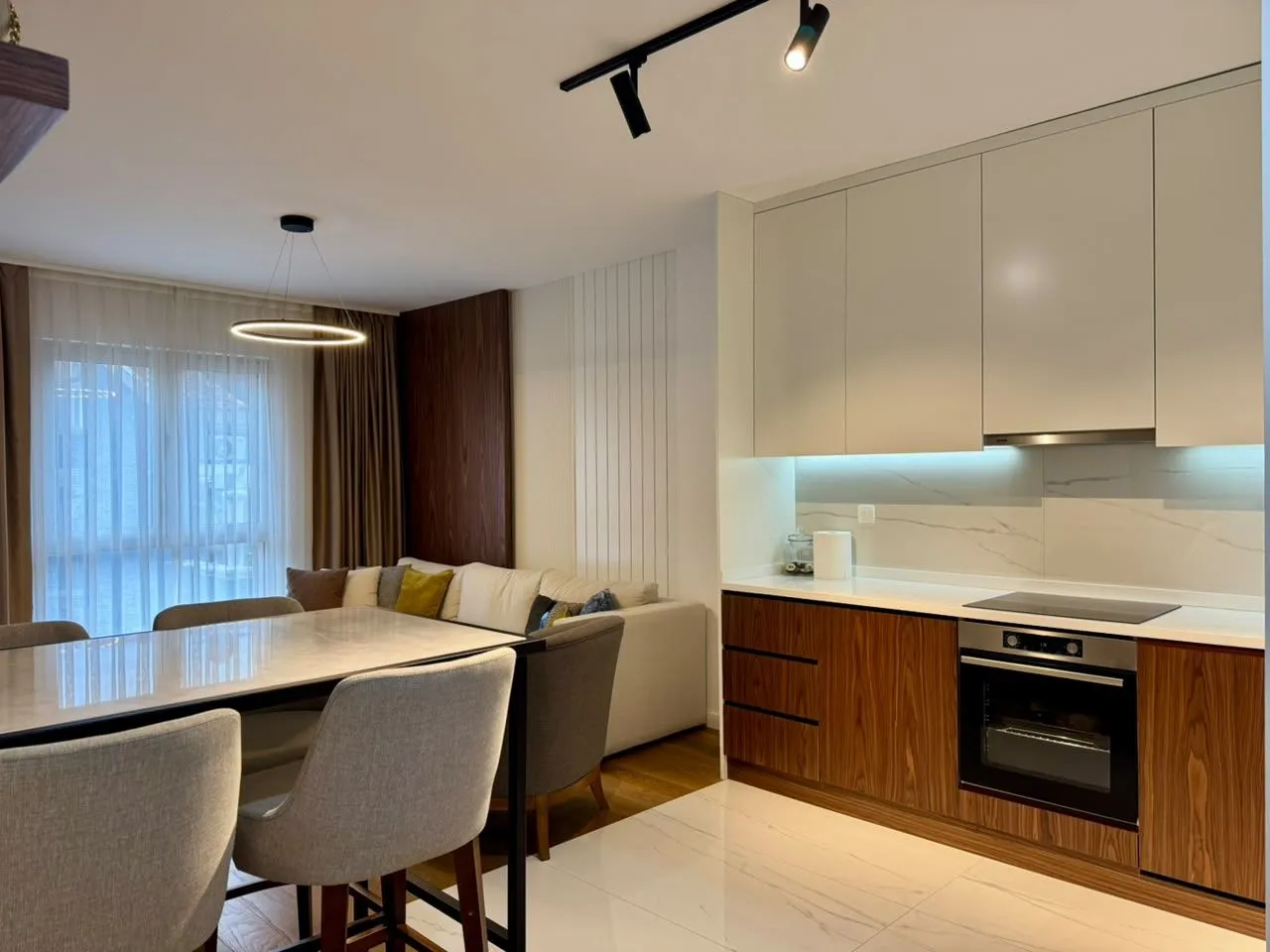 Modern living room with dining area and fitted kitchen.