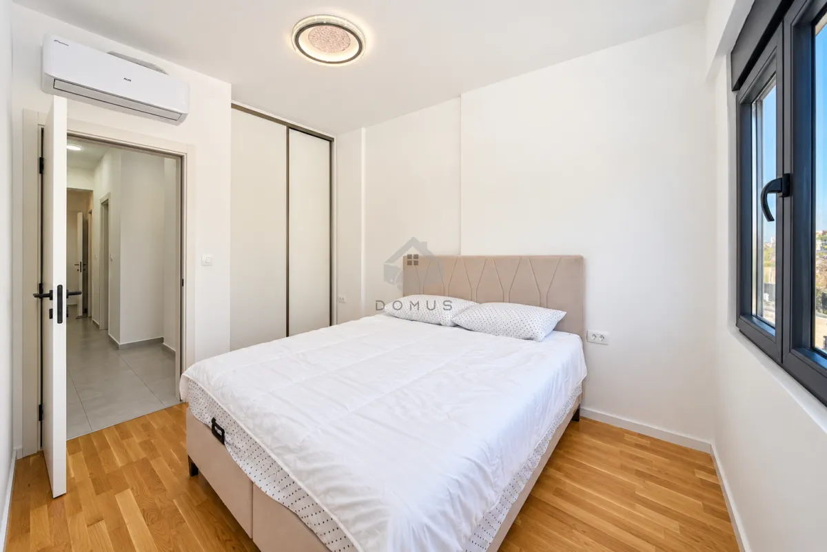 Bedroom with a double bed, built-in wardrobe and air conditioning.