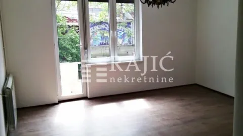 Empty room with laminate flooring and balcony access. - image 2