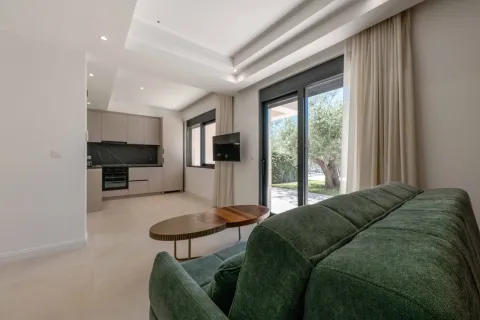 Living room with a sofa and a view of the kitchen and yard. - image 10