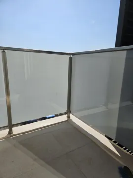 View of a terrace section with a modern glass railing. - image 5