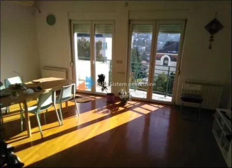 Living room with dining area, wooden flooring, and access to the terrace. - image 4