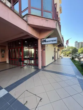 Exterior view of a ground-floor commercial space with a tiled walkway. - image 9