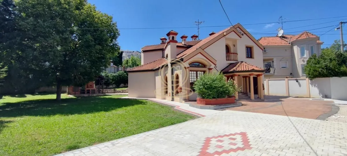 Exterior view of the house with a landscaped yard and lawn.