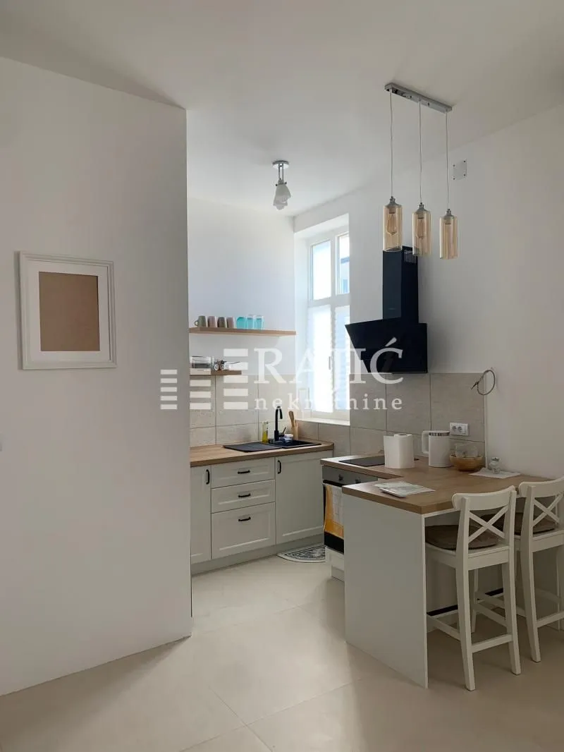 Small bright kitchen with a dining table and chairs.