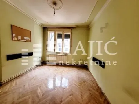Empty room with parquet flooring and a window. - image 3