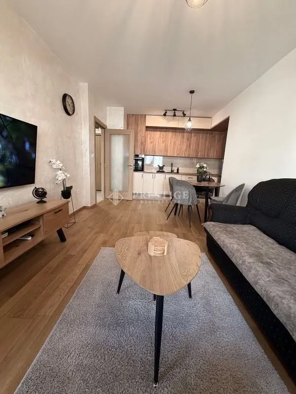Modern living room connected to the dining area and kitchen.