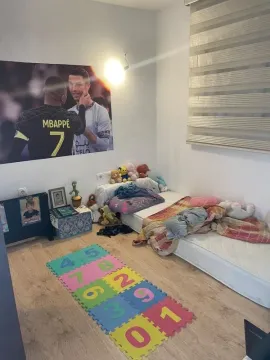 Children's bedroom with a bed, toys, and a poster on the wall. - image 3
