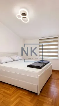 Bedroom with a double bed and parquet flooring. - image 4
