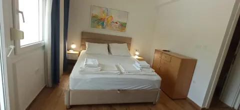 Bright bedroom with a double bed, bedside tables, and a chest of drawers. - image 6