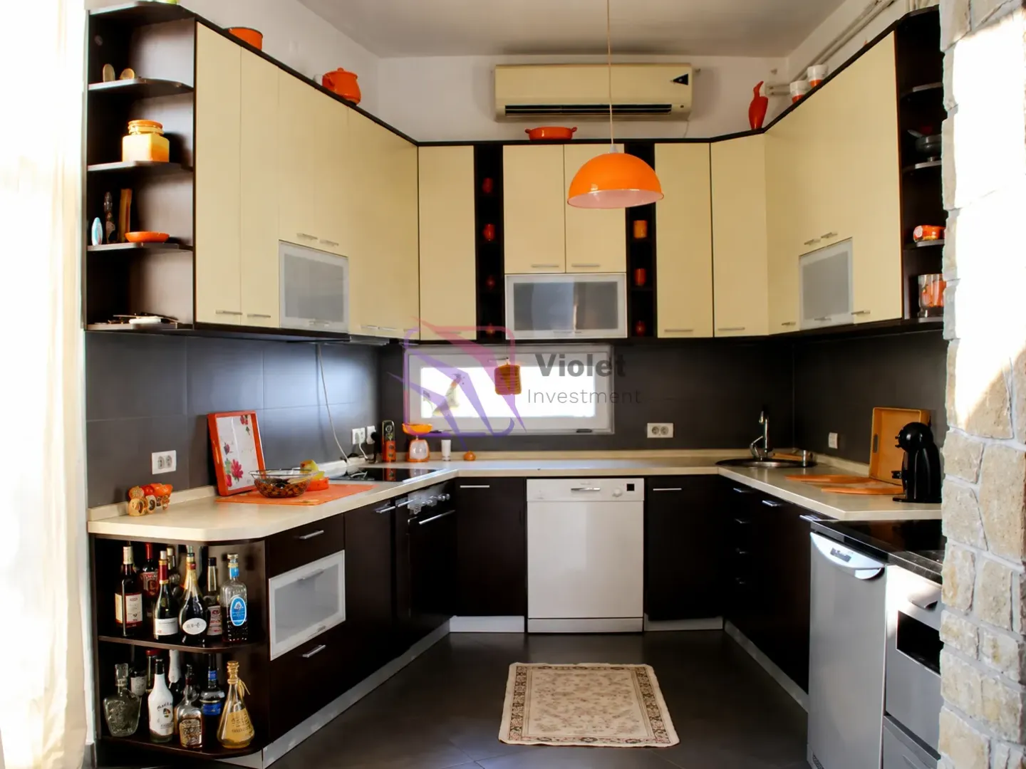 Fully equipped kitchen with a combination of dark and light cabinets.