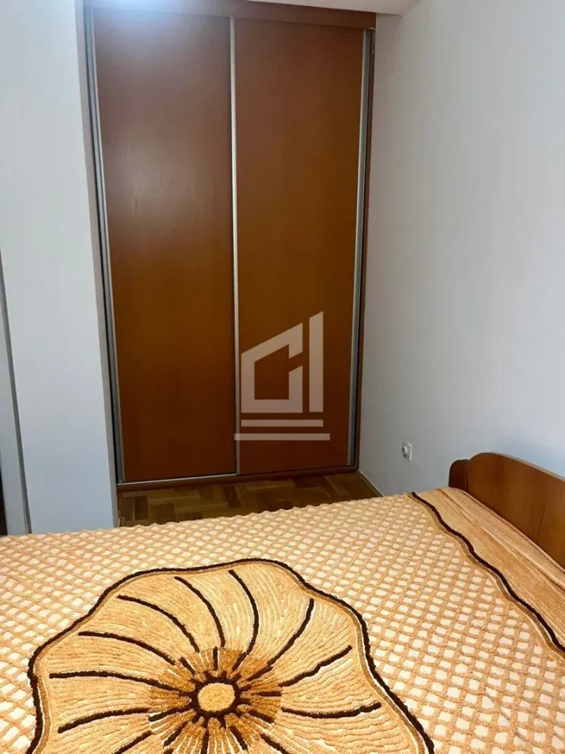 Bedroom with a bed and a fitted wardrobe.